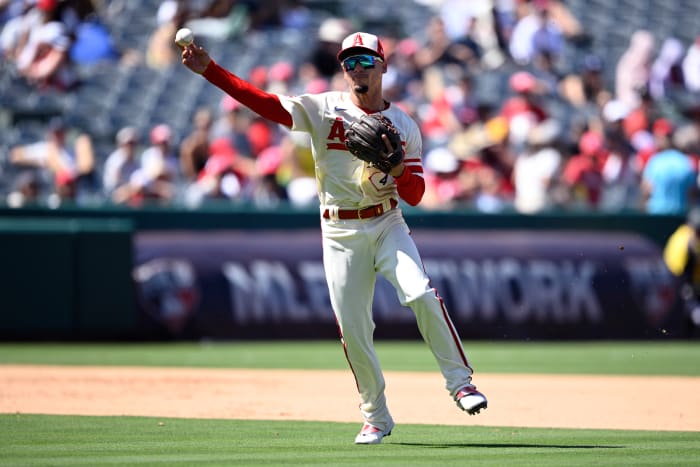 Aug 23, 2023; Anaheim, California, USA; Los Angeles Angels shortstop Andrew Velazquez (4) throws to first base against the Cincinnati Reds during the fifth inning at Angel Stadium.